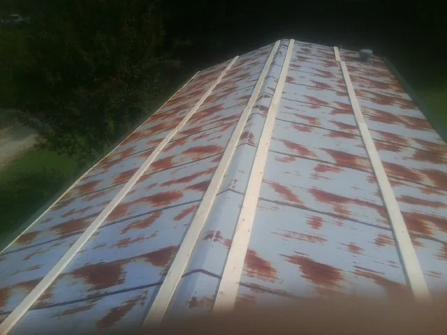 Rusted metal roof panels with new wood purlins before replacement — Storm Damage Roof Repair in Pacifica by Roofing Brothers